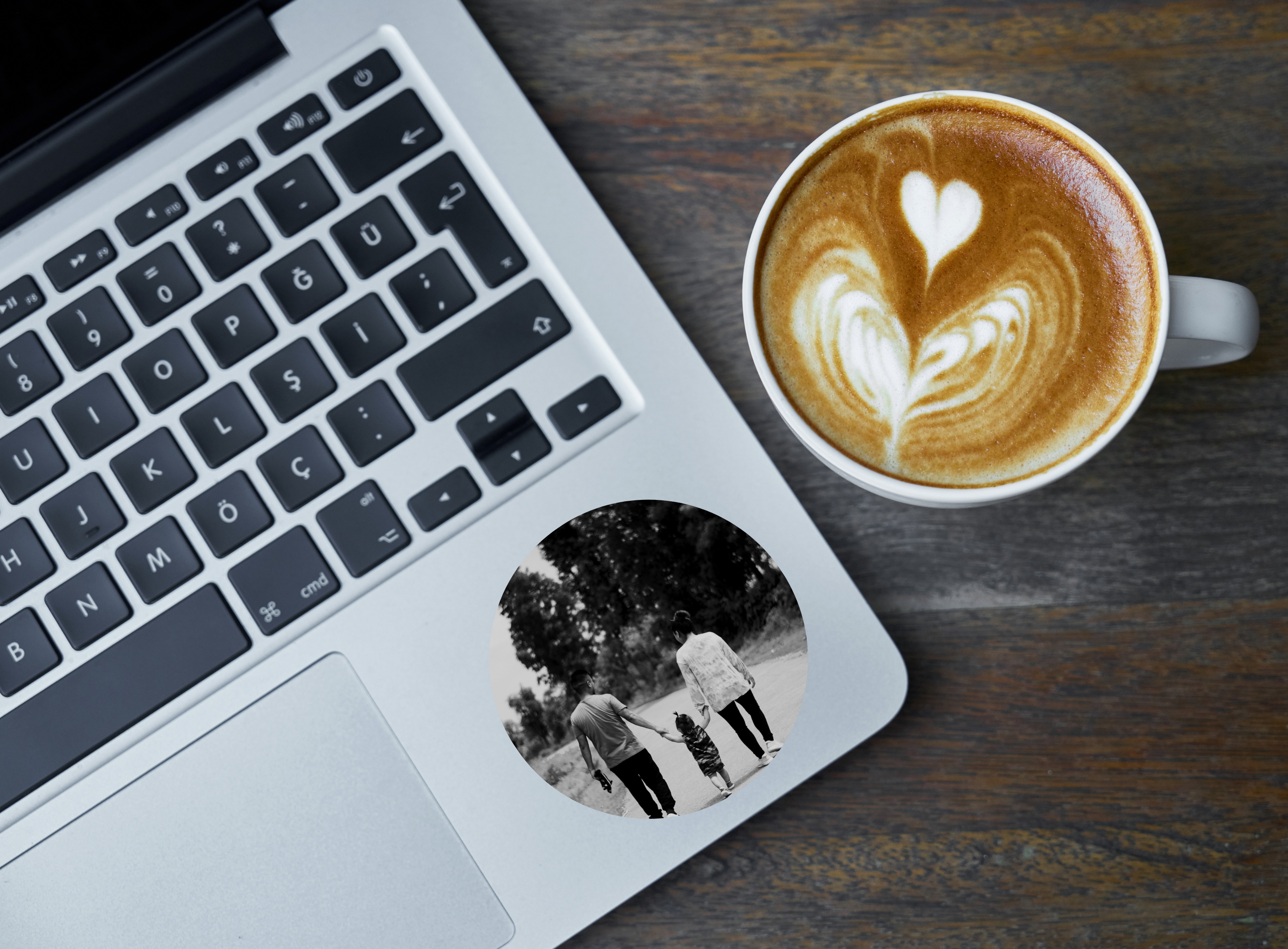 Custom photo sticker on a laptop of a family walking.